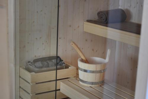 a sauna with a cup and a wooden utensil at Hotel Valtellina in Livigno