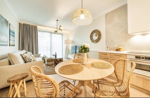 a kitchen and living room with a table and chairs at Apartament 117 - Rezydencja Niechorze in Niechorze