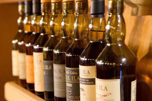 a row of wine bottles sitting on a shelf at Hotel Englhof in Zell am Ziller