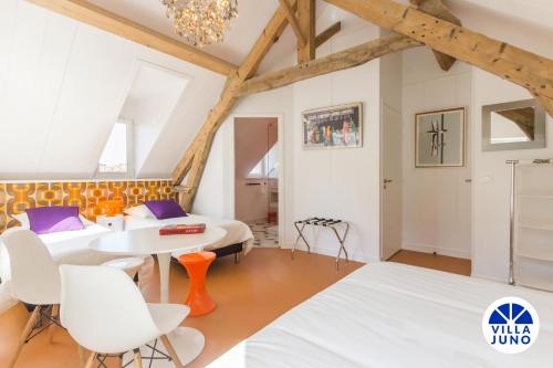 ein Schlafzimmer mit einem Tisch und Stühlen in einem Zimmer in der Unterkunft Villa Juno - Saint-Aubin-sur-Mer - Côte de nacre - Normandie - Plage débarquement in Saint-Aubin-sur-Mer