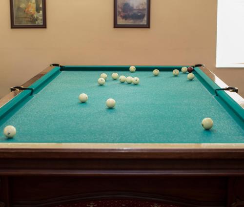 a pool table with balls on top of it at Tsaghkahovit Hotel in Tsaghkadzor