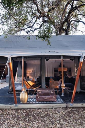 a tent with luggage and furniture in it at Jock Safari Lodge in Skukuza