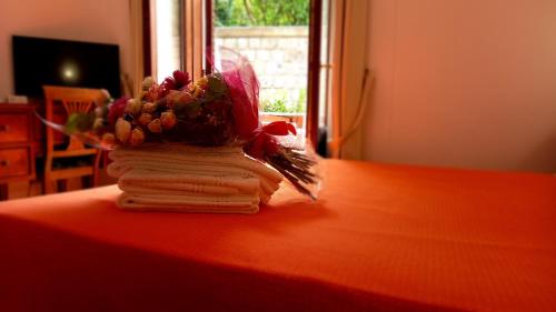 a book with a bouquet of flowers on a table at La Magnolia Sorrento - City Centre Hotel in Sorrento