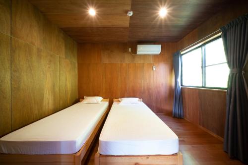 Cama o camas de una habitación en Isumi Enokisawa -いすみ 四季の家 榎澤- ペット可