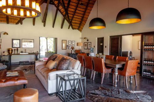 a living room with a couch and a table at Jock Safari Lodge in Skukuza