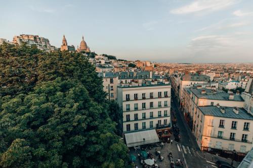 a city with tall buildings and a clock tower at Timhotel Montmartre in Paris