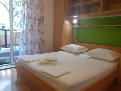 a bedroom with a bed with two towels on it at Guest House Damir in Makarska
