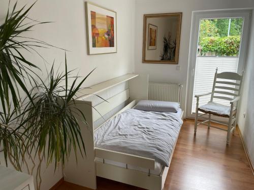 a bedroom with a bed and a desk and a chair at Apartment Oesterling in Wardenburg