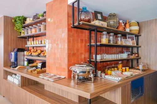 a kitchen with a counter with food on it at Timhotel Le Louvre in Paris