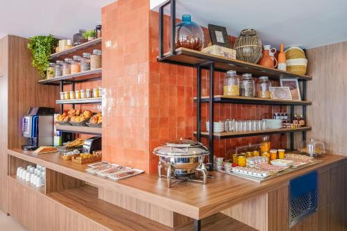 a kitchen filled with lots of different types of food at Timhotel Le Louvre in Paris