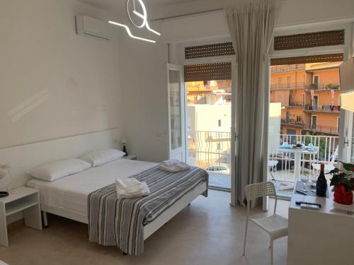 a bedroom with a bed and a balcony at La Piazza BeB in Tropea