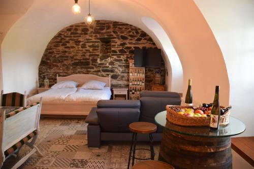 a room with a bed and a table with a basket of fruit at The Wine Cellar in the Old Gemeinde House in Brauneberg