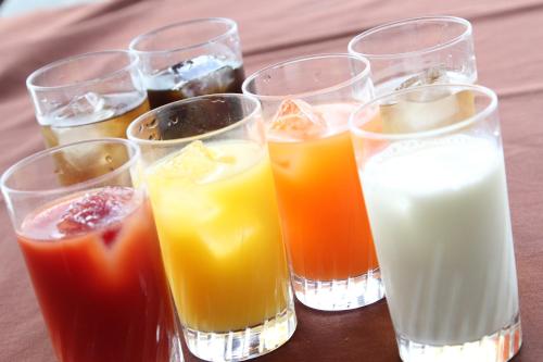 a group of glasses filled with different types of juice at Kuretake Inn Gotemba Inter Gold Cabin in Gotemba