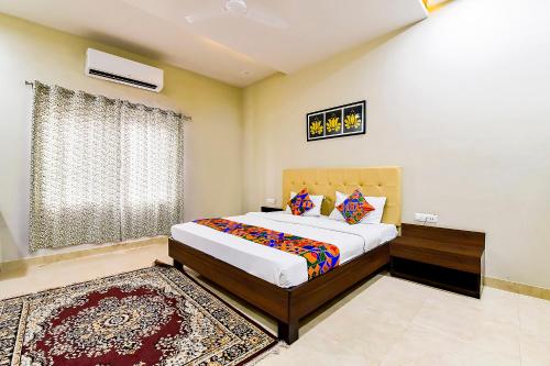 a bedroom with a large bed and a rug at FabHotel The Castle Homestay in Jaipur