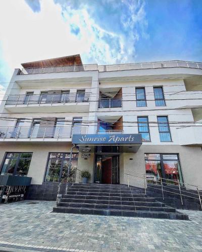 a large building with stairs in front of it at Sunrise Aparts in Polyana