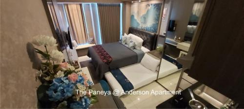 a small room with a bed and a mirror at The Paneya@Anderson Apartment in Surabaya