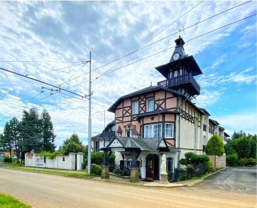 a building with a clock tower on top of it at Schlosshotel Marienbad in Mariánské Lázně