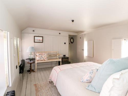 a white bedroom with a bed and a table at 12 Banks Street in Horncastle