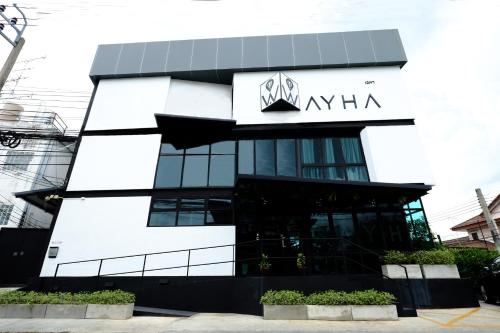 a building with a sign on top of it at Wayha Hostel Don Mueang Airport in Bangkok