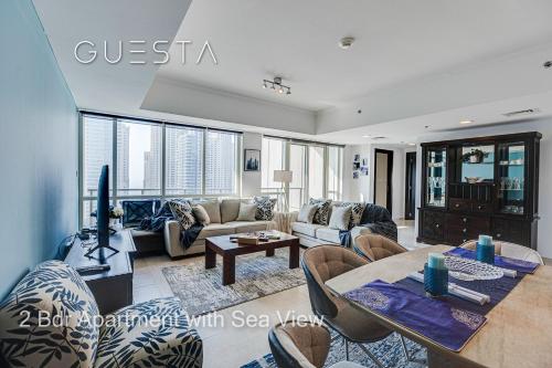 a living room with a couch and a table at Al Majara by EMAAR, Dubai Marina in Dubai
