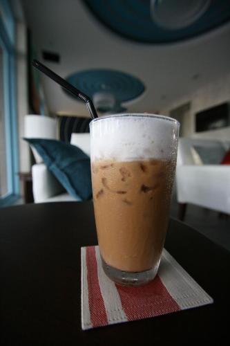 a cup of coffee sitting on a table at Apo Hotel in Krabi town