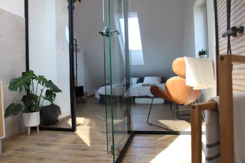 a room with a mirror and a chair and a bed at Kafe v obýváku in Bítov