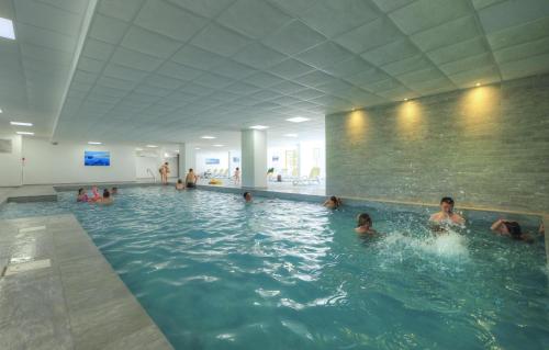 a group of people in a swimming pool at Résidence Odalys Front de Neige in Plagne Villages