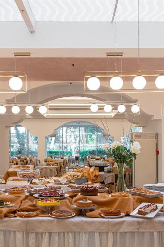a large banquet hall with tables filled with food at Hotel Adria in Milano Marittima