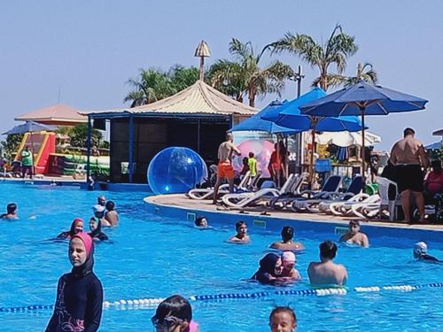 a group of people in the swimming pool at a resort at Chalets in Porto Sokhna Pyramids in Ain Sokhna