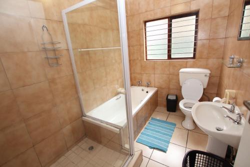 a bathroom with a shower and a toilet and a sink at Surf and Sand - Fish Eagle in Ramsgate