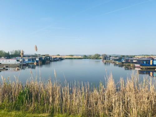 a view of a river with boats docked at The Stable, Yew Tree Farm Holidays, Tattenhall, Chester in Chester