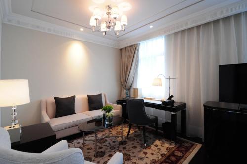 a living room with a couch and a table at Sofitel Legend People's Grand Hotel Xi'an in Xi'an