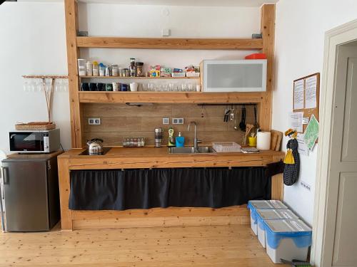 a kitchen with a counter with a sink and a refrigerator at Apartman Stiavnica in Banská Štiavnica