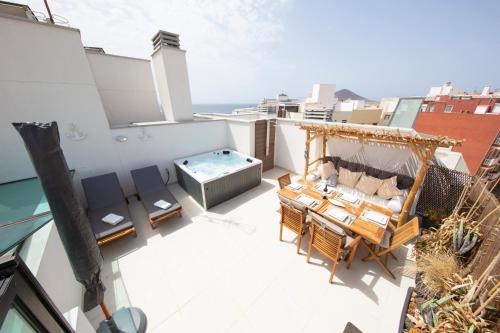 a balcony with a hot tub on top of a building at MEDANO4YOU Tina's Jacuzzi Terrace Playa Chica in El Médano