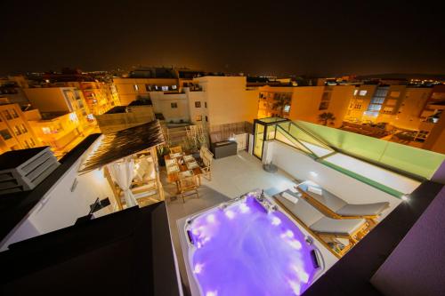 a balcony with a hot tub on top of a building at MEDANO4YOU Tina's Jacuzzi Terrace Playa Chica in El Médano