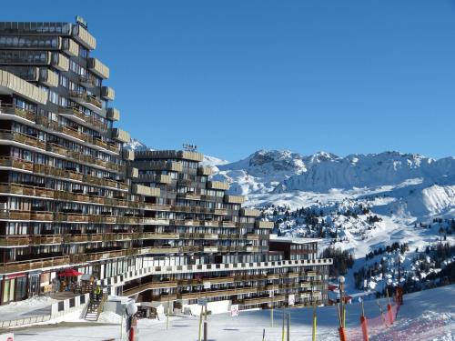 a building on top of a snow covered mountain at travelski home select - Vue Mont Blanc in Aime-La Plagne