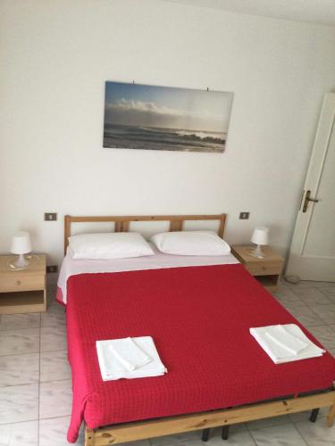 a bedroom with a bed with a red blanket at Appartamento Belvedere in Chieti