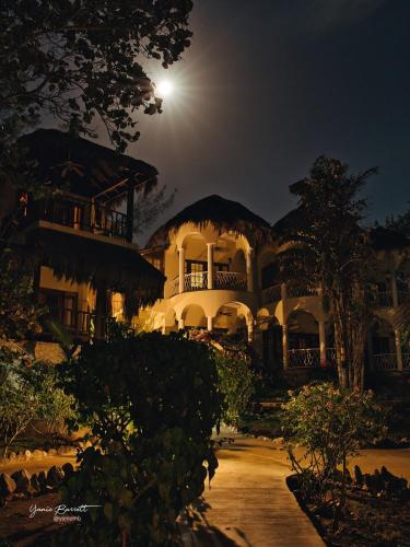 a large white house at night with a full moon at Catcha Falling Star in Negril