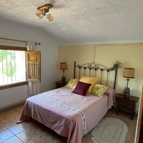 a bedroom with a bed and a ceiling at Los Manantiales Casa Rural in Alcaraz
