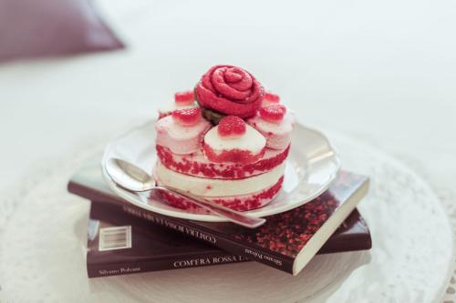 a cake sitting on top of a plate on a table at Piccolo Mondo Hotel in Follonica