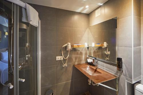 a bathroom with a sink and a shower at Nura Santa Ponsa Pins in Santa Ponsa