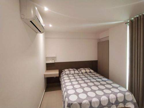 a small bedroom with a bed in a room at Premium Flat Praia Calma - PontaNegra in Natal