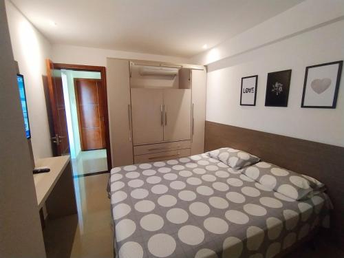 a small bedroom with a bed in a room at Premium Flat Praia Calma - PontaNegra in Natal