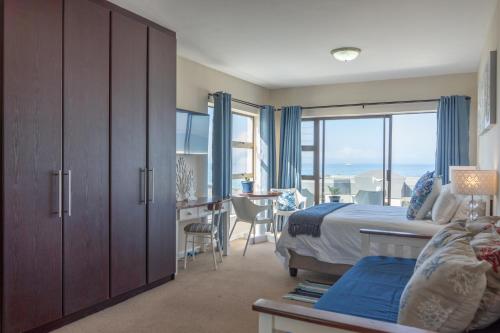 a bedroom with a bed and a desk with a table at Blue Star Villa in Tergniet