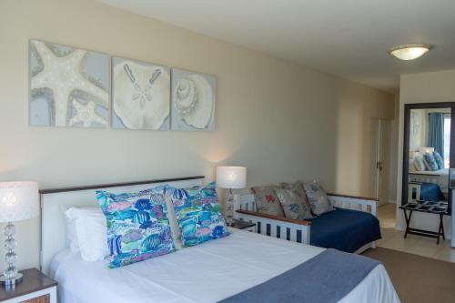 a bedroom with a white bed and a couch at Blue Star Villa in Tergniet