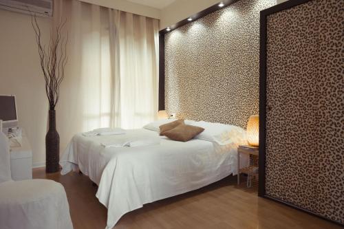 Postel nebo postele na pokoji v ubytování Piccolo Mondo Hotel