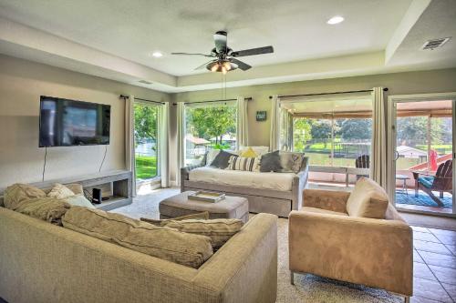 a living room with two couches and a flat screen tv at Private Dock and Slip Cedar Creek Reservoir Home in Mabank