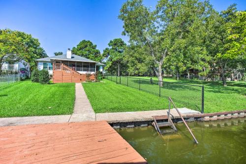 a house with a dock in the water in front of it at Private Dock and Slip Cedar Creek Reservoir Home in Mabank