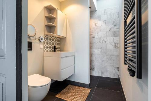 a small bathroom with a toilet and a sink at Hosted by Wendy Prins Willem 3 in Scheveningen