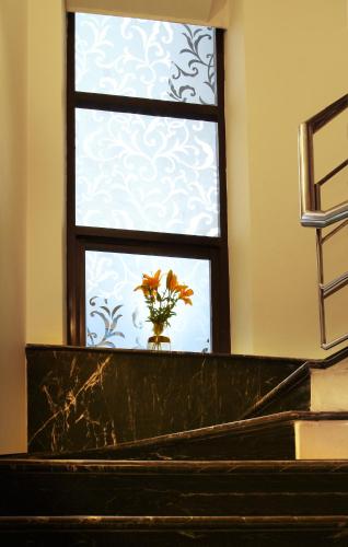 a window with a vase of flowers in front of it at Perch Arbor Suites in Gurgaon